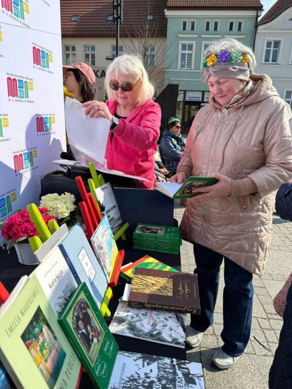 Starsze kobiety przeglądają książki na straganie