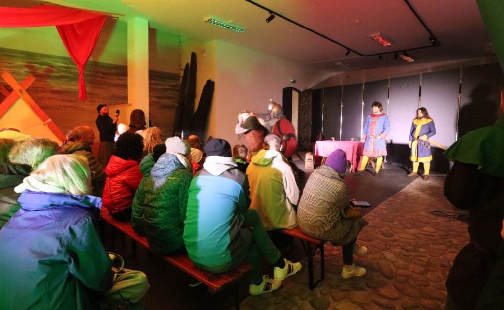 Widownia ogląda przedstawienie teatralne w pomieszczeniu