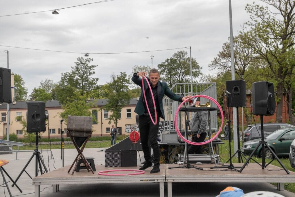 Artysta żonglujący obręczami na scenie na świeżym powietrzu