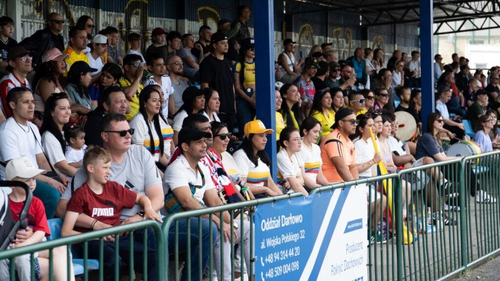 Różnorodna grupa ludzi ogląda wydarzenie sportowe