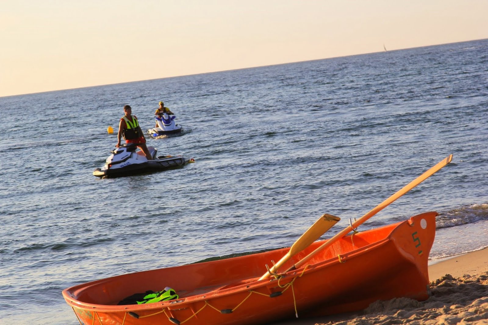 Skrzynia i skutery wodne na plaży o zachodzie słońca