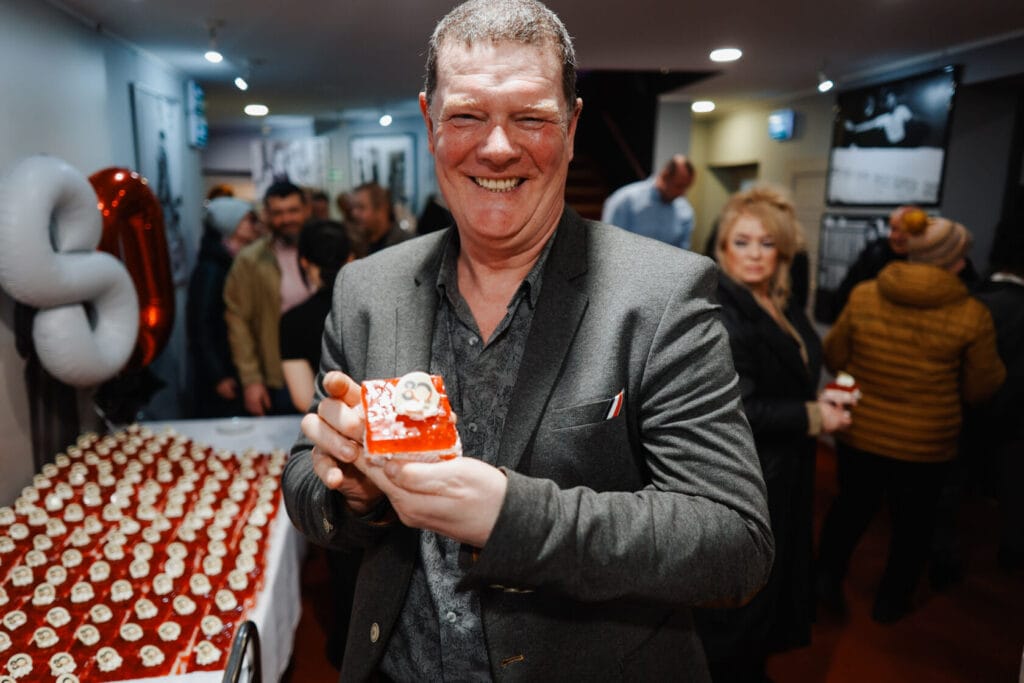 Uśmiechnięty mężczyzna prezentuje świąteczne ciastko